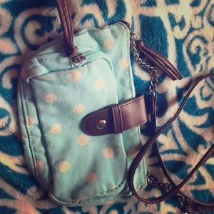 A blue purse with white polka dots